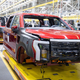 Ford F-150 Lightning pickup trucks roll through the assembly line at the Ford Rouge Electric Vehicle Center in Dearborn, Michigan.